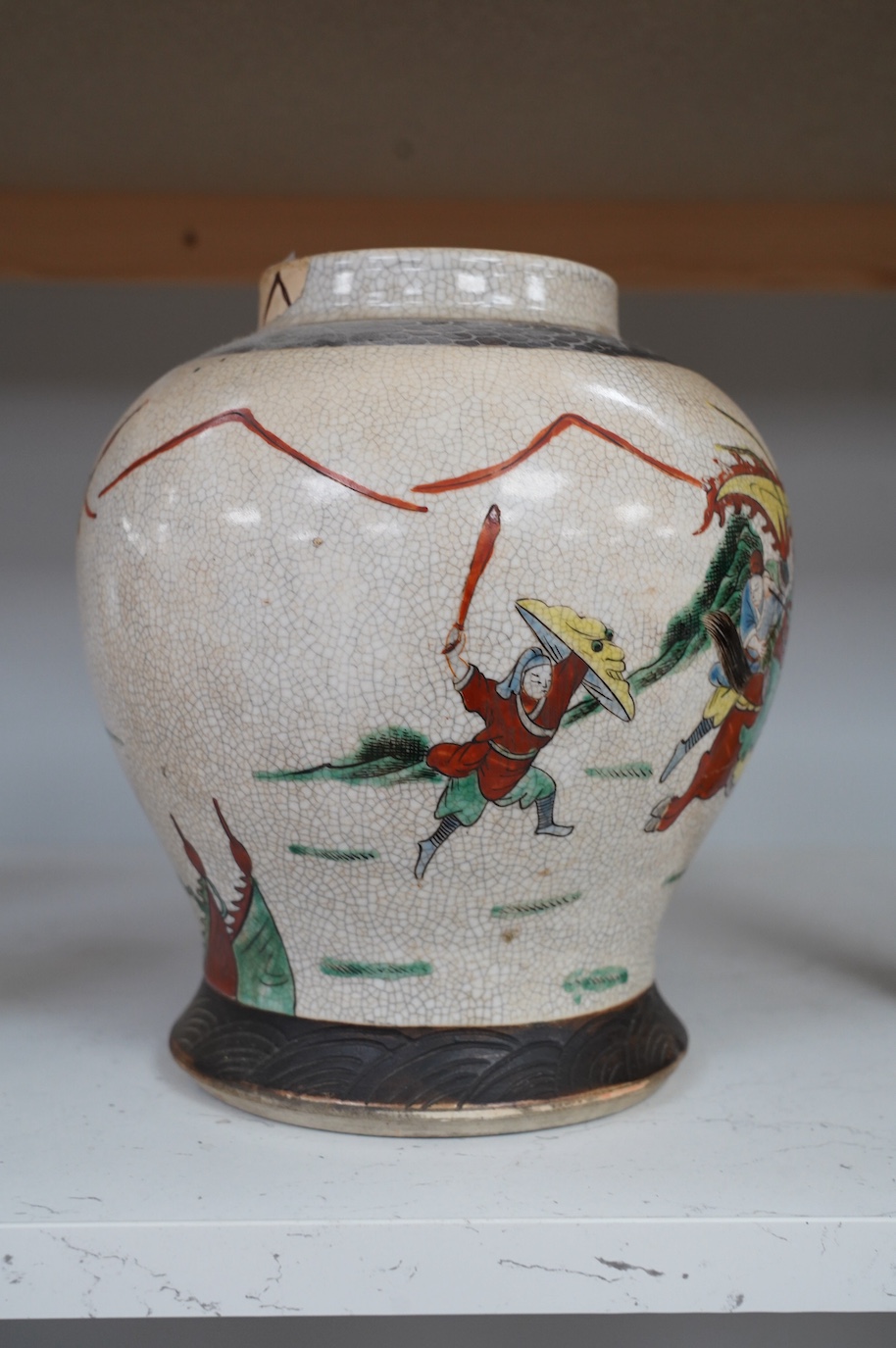 A Chinese crackle glazed famille verte vase, 24cm. Condition - poor